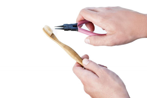 Dupont bristles being shown as someone removing the bristles with pliers- Benefits and Sustainability